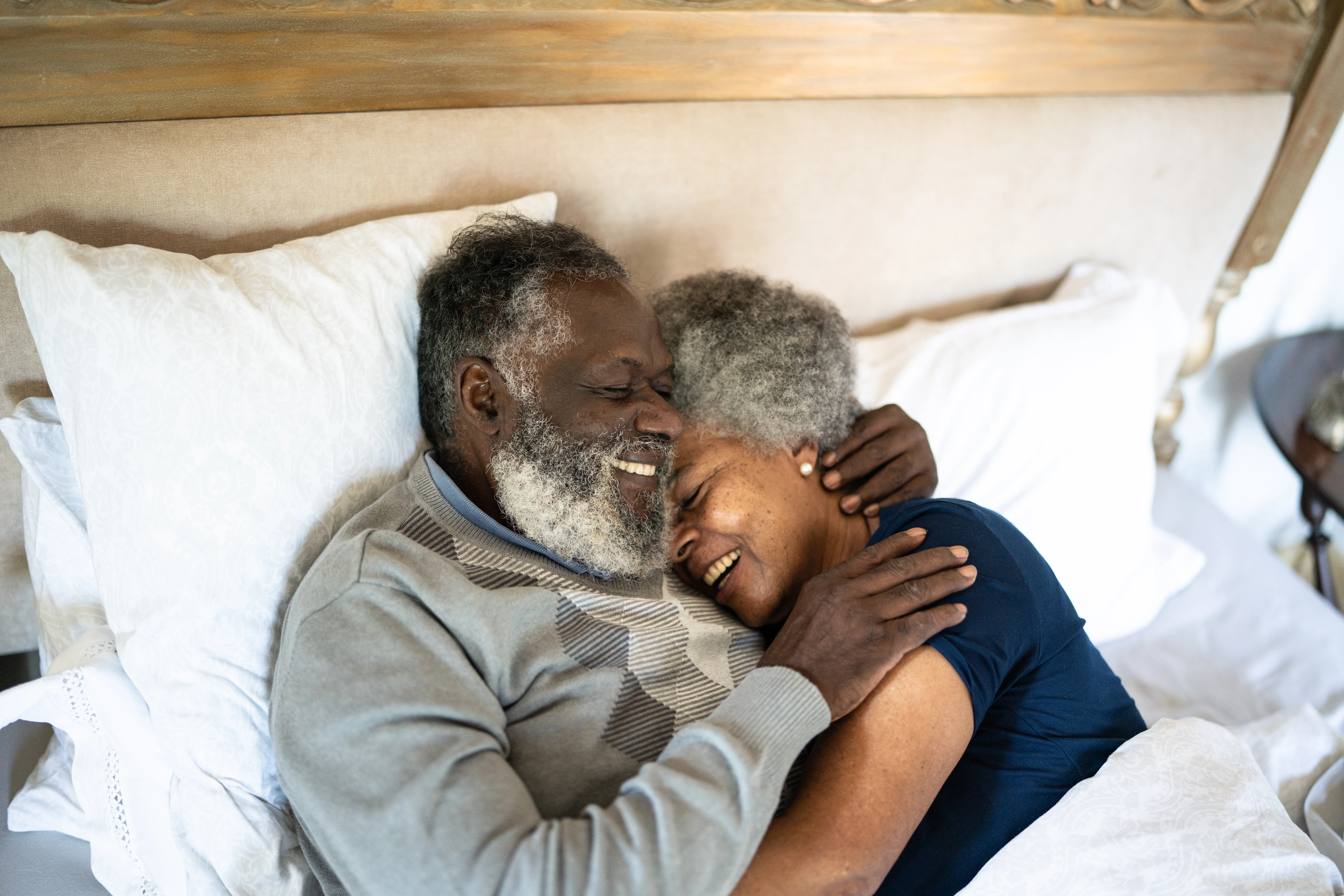 a man and a woman lying in bed