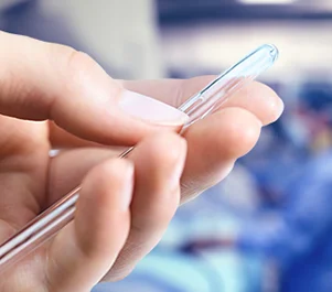 a hand holding a Continence Care product