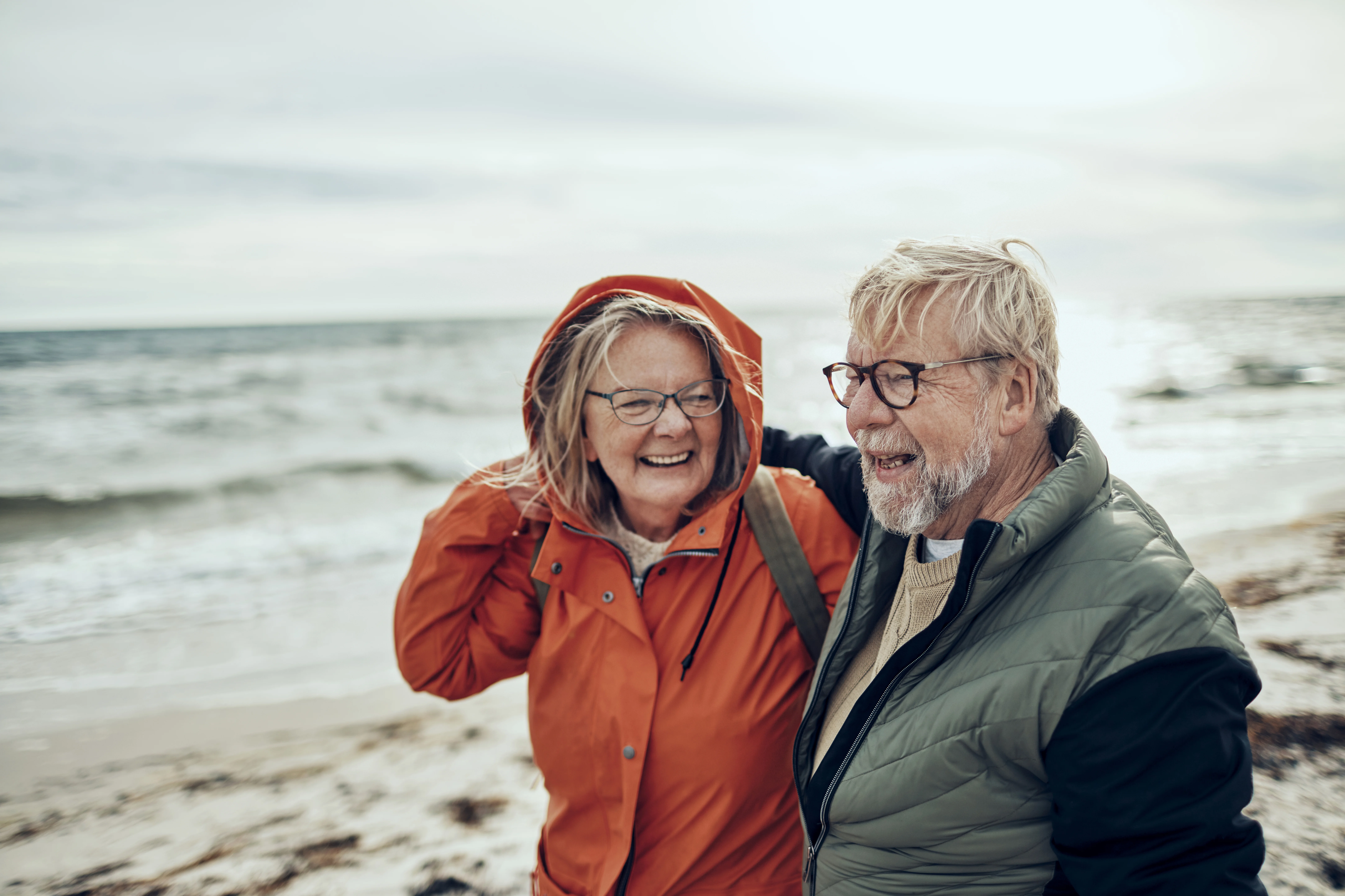 a man and woman standing on a beach