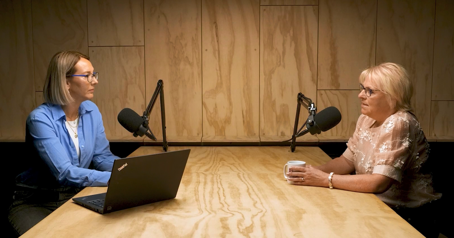 women sitting at a table with microphones and laptops